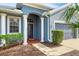 Front entrance with white columns, dark door, and brick walkway at 4360 85Th Avenue E Cir, Parrish, FL 34219