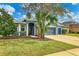 Single-story home with gray exterior, landscaping, and a two-car garage at 4360 85Th Avenue E Cir, Parrish, FL 34219