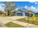 House exterior with gray paint, two-car garage, and nicely manicured lawn at 4360 85Th Avenue E Cir, Parrish, FL 34219