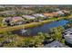 Community view showcasing lake, fountain, and various homes at 45 Grand Palms Blvd, Englewood, FL 34223