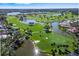 Golf course community with lake and homes at 45 Grand Palms Blvd, Englewood, FL 34223