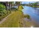 Landscaped backyard with lake access at 45 Grand Palms Blvd, Englewood, FL 34223