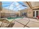 Spacious pool and spa with covered patio and lounge chairs at 45 Grand Palms Blvd, Englewood, FL 34223