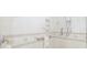 Walk-in shower with grab bars and tiled walls at 45 Grand Palms Blvd, Englewood, FL 34223