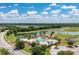 Aerial view of community with pool, tennis court, and lake at 4512 Renwick Dr, Parrish, FL 34219