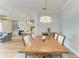 Dining room with wood table and chairs, view into living area and kitchen at 4512 Renwick Dr, Parrish, FL 34219