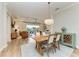 Open dining room with light wood table and chairs, adjacent to living area at 4512 Renwick Dr, Parrish, FL 34219