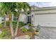 Landscaped front yard with palm trees and a walkway to the entrance at 4512 Renwick Dr, Parrish, FL 34219