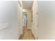 Long hallway with light colored walls and wood flooring at 4512 Renwick Dr, Parrish, FL 34219