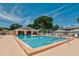 Inviting outdoor community pool area with picnic table, shade, and pool chairs at 4728 Sand Trap Street E Cir, Bradenton, FL 34203