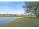 Peaceful pond view, showcasing a lush green golf course at 4728 Sand Trap Street E Cir, Bradenton, FL 34203