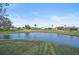 Scenic pond view with golf course and houses in the background at 4728 Sand Trap Street E Cir, Bradenton, FL 34203