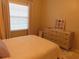 Cozy bedroom with a comfortable bed and dresser at 4751 Travini Cir # 4-108, Sarasota, FL 34235