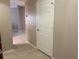 Clean and bright hallway with neutral walls and tile floors at 4751 Travini Cir # 4-108, Sarasota, FL 34235