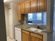 Modern kitchen with granite countertops and wood cabinets at 4751 Travini Cir # 4-108, Sarasota, FL 34235