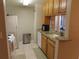 View of kitchen with granite countertops, white appliances, and wood cabinets at 4751 Travini Cir # 4-108, Sarasota, FL 34235