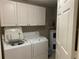 Laundry room with washer, dryer, and storage cabinets at 4751 Travini Cir # 4-108, Sarasota, FL 34235