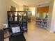 Open living room with room divider, comfy chair, and view of dining area at 4751 Travini Cir # 4-108, Sarasota, FL 34235