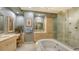 Elegant bathroom with soaking tub, double vanity, and large shower at 50 Central Ave # 17Phc, Sarasota, FL 34236