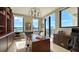 Bright home office features a large desk, built-in shelving, and stunning city views at 50 Central Ave # 17Phc, Sarasota, FL 34236