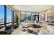 Spacious living room with curved sofa, city views, and modern decor at 50 Central Ave # 17Phc, Sarasota, FL 34236