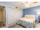 Bedroom with a blue wall and a floral comforter at 501 Spring Lakes Blvd # 501, Bradenton, FL 34210