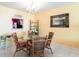 Well-lit dining area, glass table, and wicker chairs at 501 Spring Lakes Blvd # 501, Bradenton, FL 34210