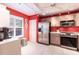 Modern kitchen featuring stainless steel appliances and red walls at 501 Spring Lakes Blvd # 501, Bradenton, FL 34210