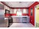 Updated kitchen with stainless steel appliances and red walls at 501 Spring Lakes Blvd # 501, Bradenton, FL 34210