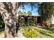 Relaxing patio area with lush landscaping and large oak tree at 501 Spring Lakes Blvd # 501, Bradenton, FL 34210