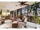 Bright sunroom with wicker furniture and view of the backyard at 501 Spring Lakes Blvd # 501, Bradenton, FL 34210