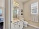 Guest bathroom with single vanity, shower/tub combo, and neutral decor at 5099 Flag St, Sarasota, FL 34232