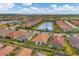 Aerial view of homes and lake in a community at 5116 Tivoli Run, Bradenton, FL 34211