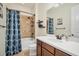 Clean bathroom with tub shower combo, vanity, and geometric patterned shower curtain at 5116 Tivoli Run, Bradenton, FL 34211