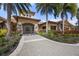 Mediterranean-style clubhouse exterior with palm trees and landscaping at 5116 Tivoli Run, Bradenton, FL 34211