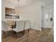 Elegant dining room featuring a glass-top table, chandelier, and neutral-toned chairs at 5116 Tivoli Run, Bradenton, FL 34211