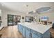 Open concept kitchen with light blue island and marble countertops at 5116 Tivoli Run, Bradenton, FL 34211