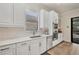 Modern white kitchen with stainless steel appliances and marble countertops at 5116 Tivoli Run, Bradenton, FL 34211