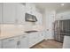 Modern white kitchen with stainless steel appliances and marble countertops at 5116 Tivoli Run, Bradenton, FL 34211