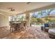 Covered patio with dining table and seating area near the pool at 5116 Tivoli Run, Bradenton, FL 34211