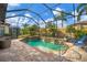 Relaxing pool and spa with covered patio and waterfall feature at 5116 Tivoli Run, Bradenton, FL 34211