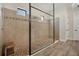 Large walk-in shower with pebble floor and glass enclosure at 5116 Tivoli Run, Bradenton, FL 34211