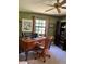 Bright home office features a large desk, comfortable chair, and built-in wooden cabinet at 5134 241St E St, Myakka City, FL 34251