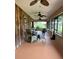 Relaxing screened porch with ceiling fans and wicker dining set at 5134 241St E St, Myakka City, FL 34251