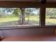 Enjoy tranquil views from this screened porch overlooking a lush green landscape at 5134 241St E St, Myakka City, FL 34251