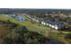 Aerial view showcasing community and golf course at 5211 Mahogany Run Ave # 124, Sarasota, FL 34241