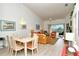 Bright dining area with table and chairs, adjacent to living room at 5211 Mahogany Run Ave # 124, Sarasota, FL 34241