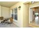 Condo entryway with small table and chairs, leading into the home at 5211 Mahogany Run Ave # 124, Sarasota, FL 34241