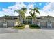 Condo building with attached garages and tropical landscaping at 5211 Mahogany Run Ave # 124, Sarasota, FL 34241