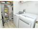 Laundry room with washer, dryer, and shelving at 5211 Mahogany Run Ave # 124, Sarasota, FL 34241